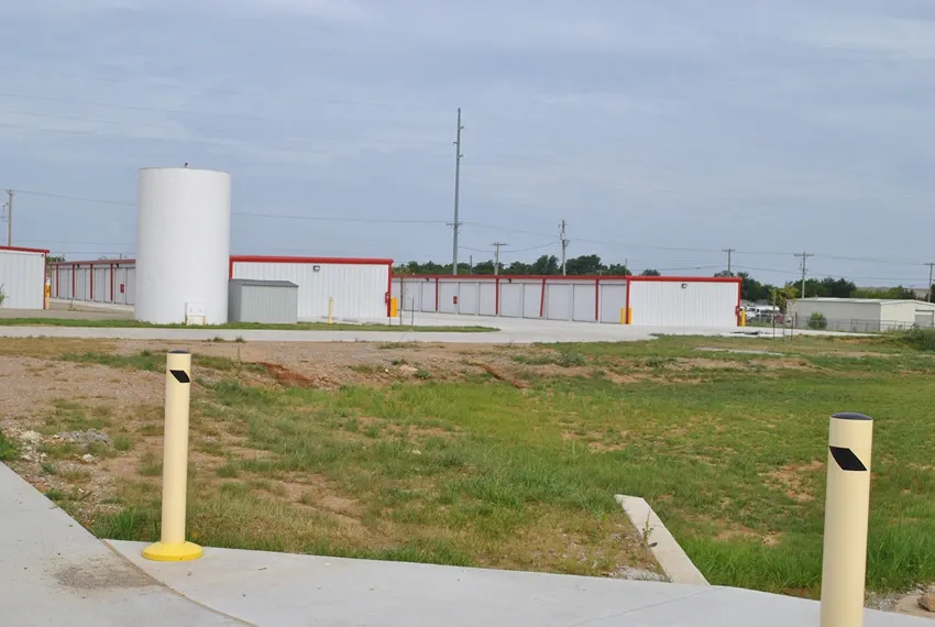Gravel entrance at gated facility.