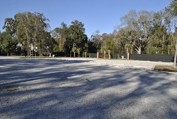 Open gravel parking spaces.