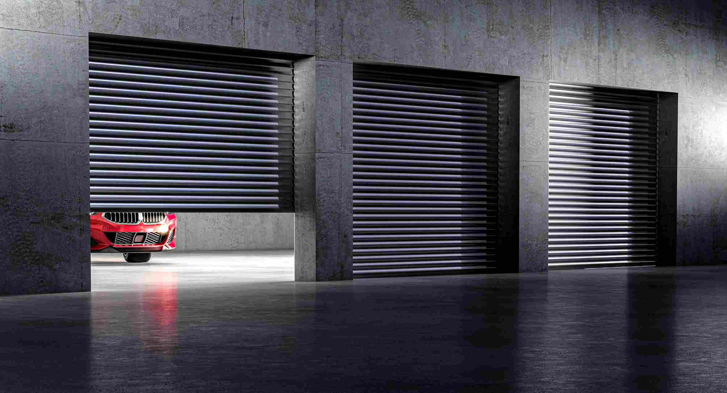 A red car inside a garage in an enclosed vehicle storage facility