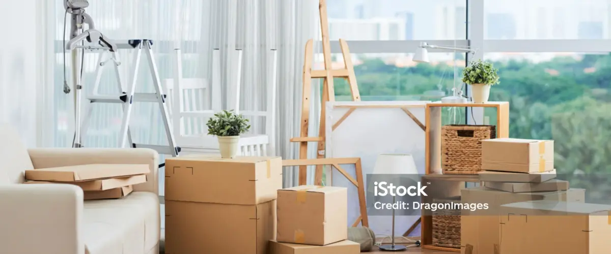 Artwork supplies and an easel packed in boxes for art storage